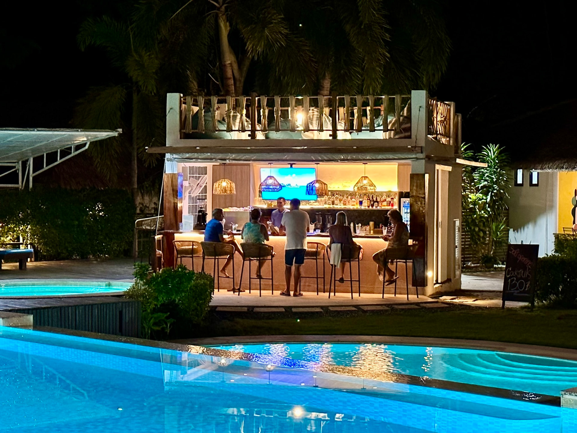 Northstar Bar at TwinBay Resort in the evening, guests along the lit counter